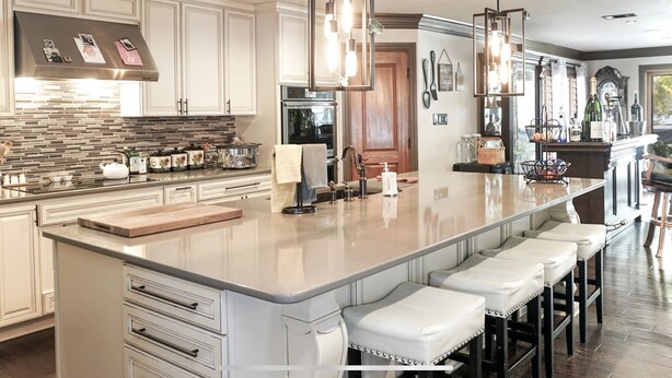 A spacious kitchen with a large island, modern appliances, and bar seating. - Amazing lakefront home with custom boat dock! (Quinlan)