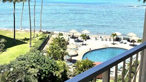 A resort with a pool, lounge chairs, and palm trees. - Spacious 2bedroom/2bath Beach Front Condo (Lahaina)