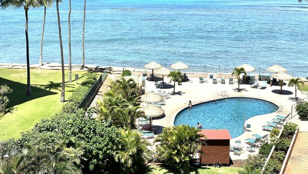 A resort with a pool, lounge chairs, and palm trees. - Spacious 2bedroom/2bath Beach Front Condo (Lahaina)