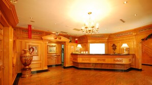 A spacious lobby with a marble floor, a reception desk, and a chandelier. - Karohotel (Kaohsiung)