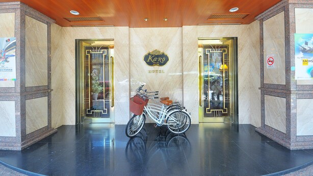 A hotel entrance with a white bicycle parked in front, a sign reading "Karo Hotel", and a no-smoking sign on the wall. - Karohotel (Kaohsiung)
