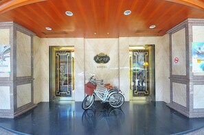 A hotel entrance with a white bicycle parked in front, a sign reading "Karo Hotel", and a no-smoking sign on the wall. - Karohotel (Kaohsiung)