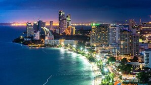 A coastal cityscape with high-rise buildings, a beach, and a marina. - Amethyst Hotel Pattaya (Pattaya)