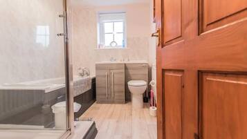 Bathtub, hair dryer, towels, toilet paper