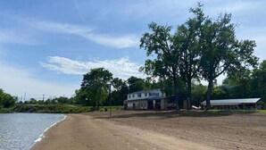 A beach with a house and a covered area.