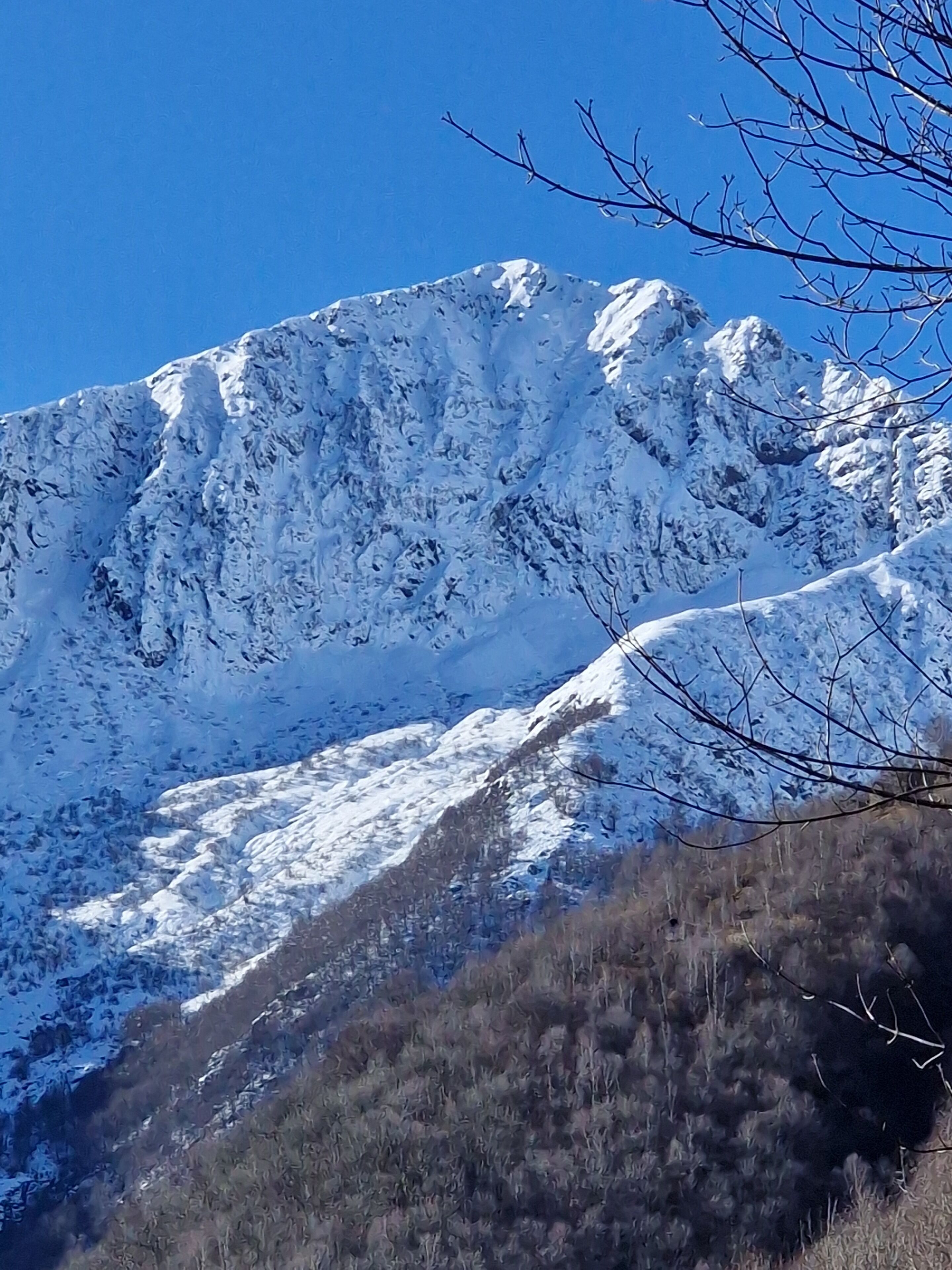 A snow-covered mountain with a clear blue sky.
