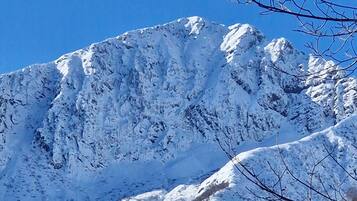 A snow-covered mountain with a clear blue sky.