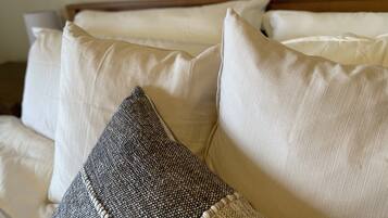 A bed with multiple pillows, including a textured one.