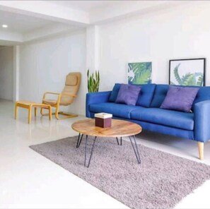 Relax in this stylish living room with a sofa, coffee table, and chairs.