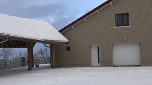 A building with a garage and a covered area. - Spacious, well-equipped, in a breathtaking setting (Mournans-Charbonny)