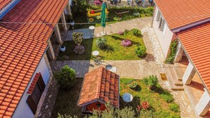 A courtyard with a swimming pool, outdoor seating, and a small garden area. - Villa Trkalj Zadarvillas (Policnik)