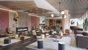A modern lobby with a mix of seating areas, a fireplace, and a bar. - Wifi, 50m from resort center, swimming pool, terrace, balcony, tv, ski locker, 52m², Le Corbier (Le Corbier)