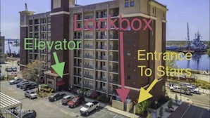 A multi-story building with an elevator and an entrance to stairs. - Riverfront balcony  WSR #10 (Wilmington)