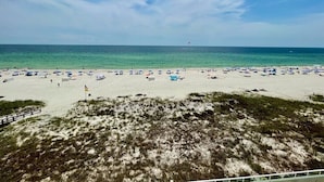A beach with numerous umbrellas and people, a clear sky, and a distant buoy. - Silver Beach 504 | Updated, Direct Beach Front, Pet Friendly! (Orange Beach)