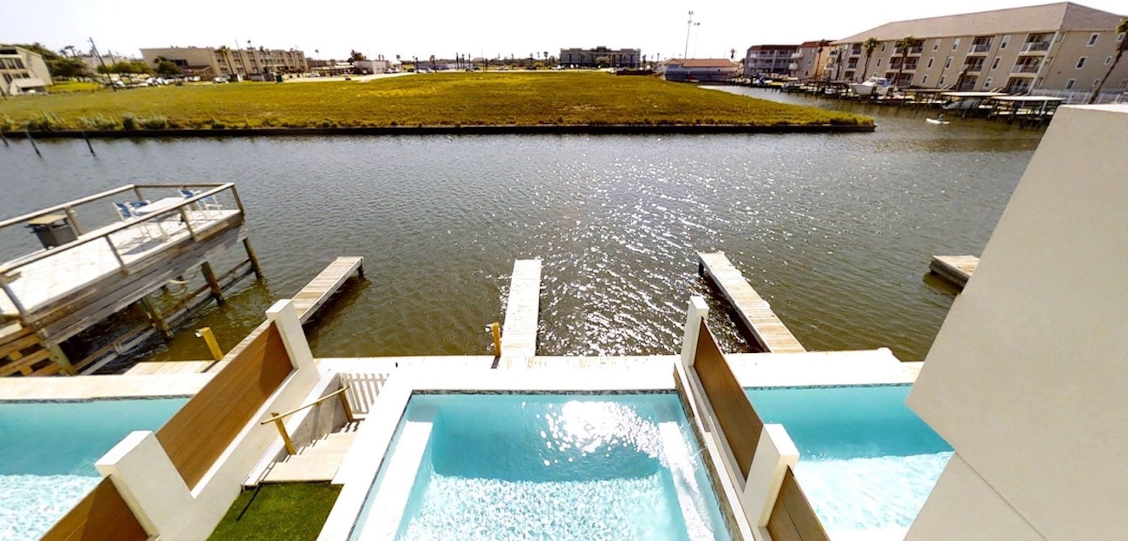 View of the pool, dock, & canal from the third-story deck.