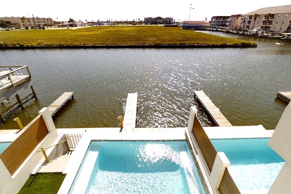View of the pool, dock, & canal from the third-story deck.
