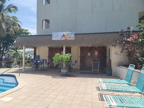 A Caribbean-themed restaurant with outdoor seating and a pool. - Ocean View Retreat.. Walk to Sapphire Beach! (St Thomas)