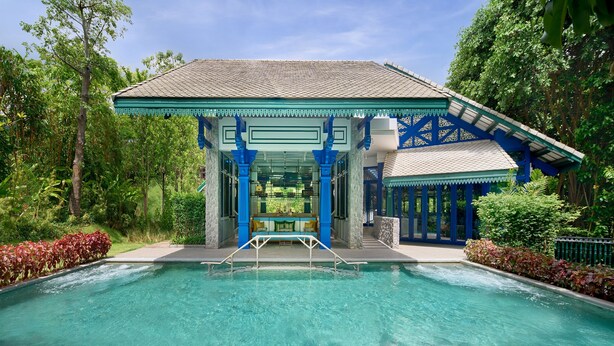 A pool area with a covered seating area and a view of the surrounding greenery. - Intercontinental Khao Yai Resort by IHG (Pak Chong)