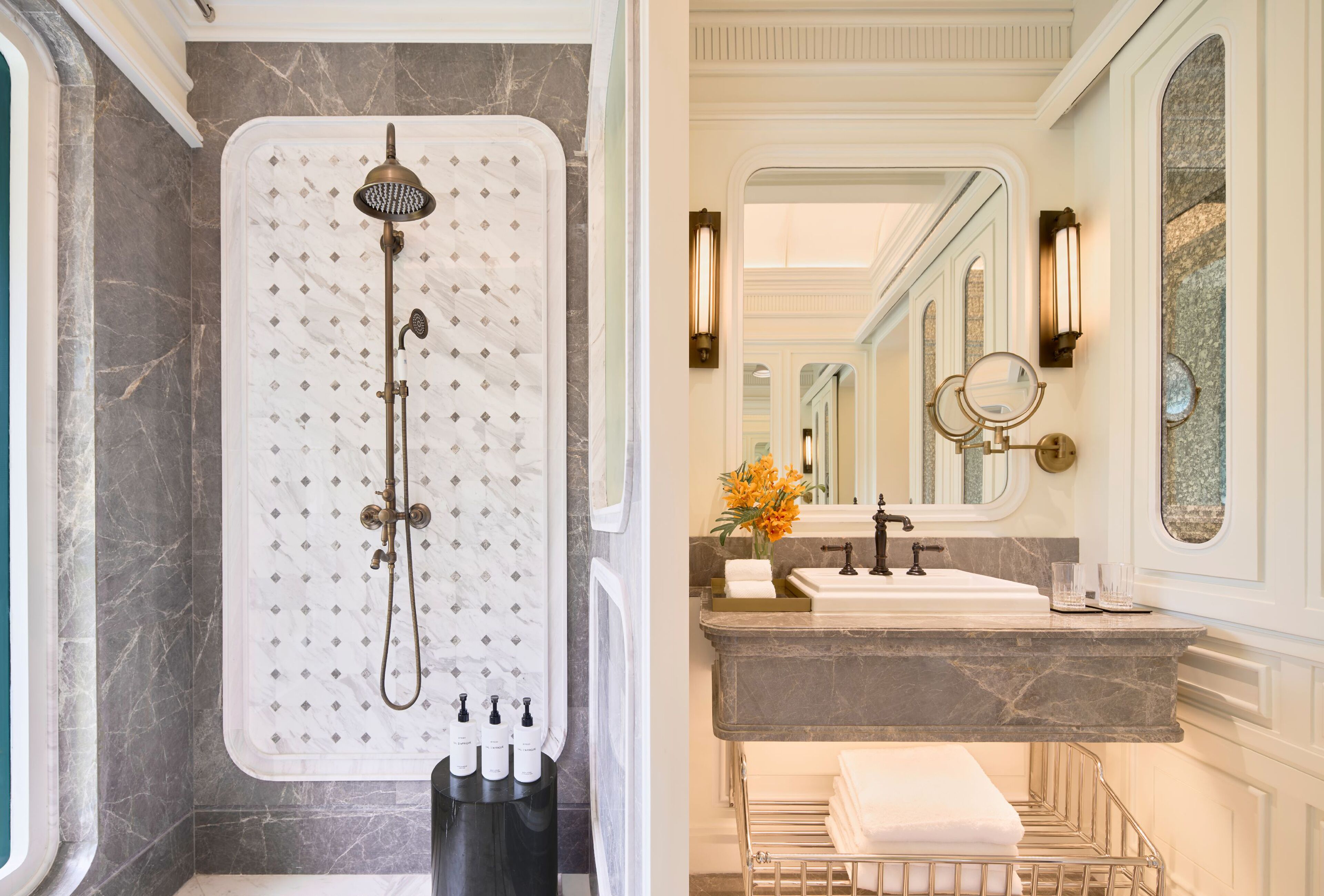 A bathroom with a marble shower, a sink with a vanity, and a towel rack.
