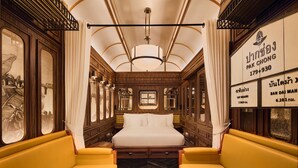 A luxurious room with a large bed, wooden paneling, and a chandelier. - Intercontinental Khao Yai Resort by IHG (Pak Chong)
