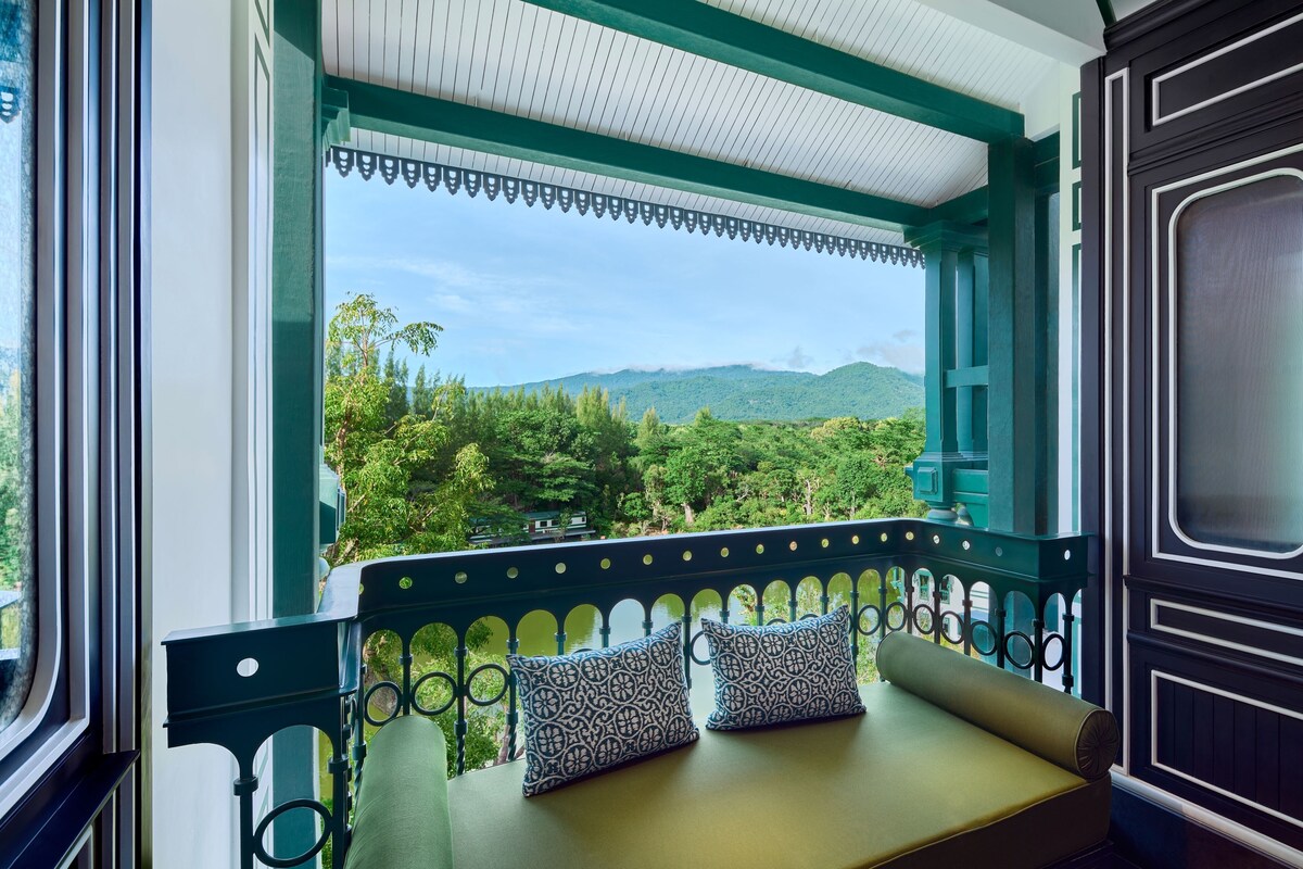 A balcony with a view of a mountainous landscape.