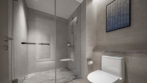 A modern bathroom with a glass-enclosed shower, a toilet, and a marble floor.