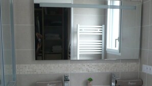 A modern bathroom with a large mirror, a white sink, and a wooden vanity. - Contemporary villa, 5' town center and beach 10 minutes by bike. (Capbreton)