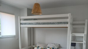 A bunk bed with a white frame, a woven pendant light, and patterned pillows. - Contemporary villa, 5' town center and beach 10 minutes by bike. (Capbreton)