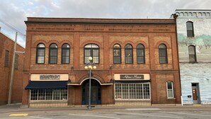 A brick building with two storefronts, one labeled "Culinary Co." and the other "Atton Marie Photography."