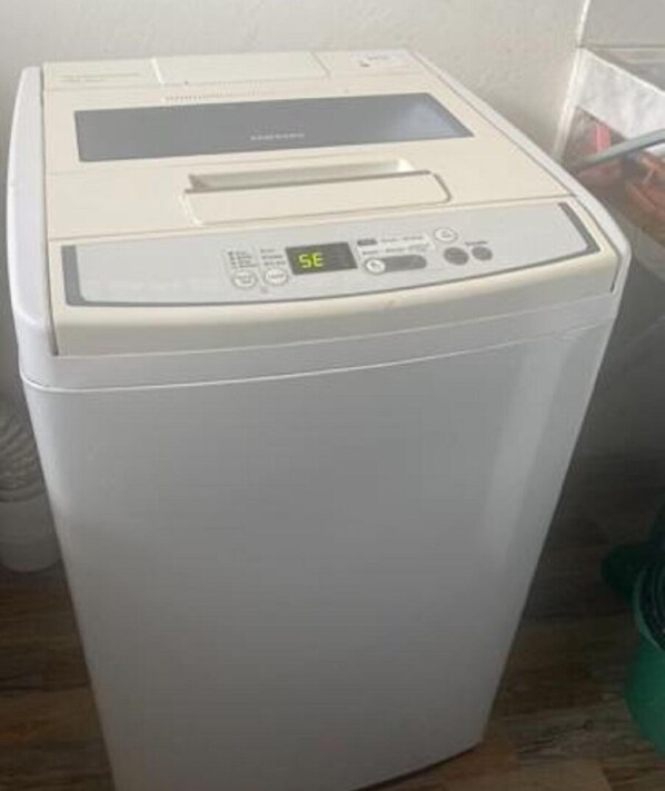 A white, compact, front-loading washing machine with a digital display and control panel. - quiet and lovely place with fireplace (Peñol)