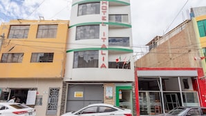 Un hotel de varios pisos con un cartel llamativo que dice "HOTEL ITALIA".