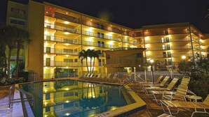 A hotel with a swimming pool, multiple balconies, and outdoor seating. - Renovated  Condo with Luxury Amenities in Perfect Beach Location (Marco Island)