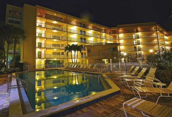 Relax by the pool surrounded by comfortable lounge chairs.