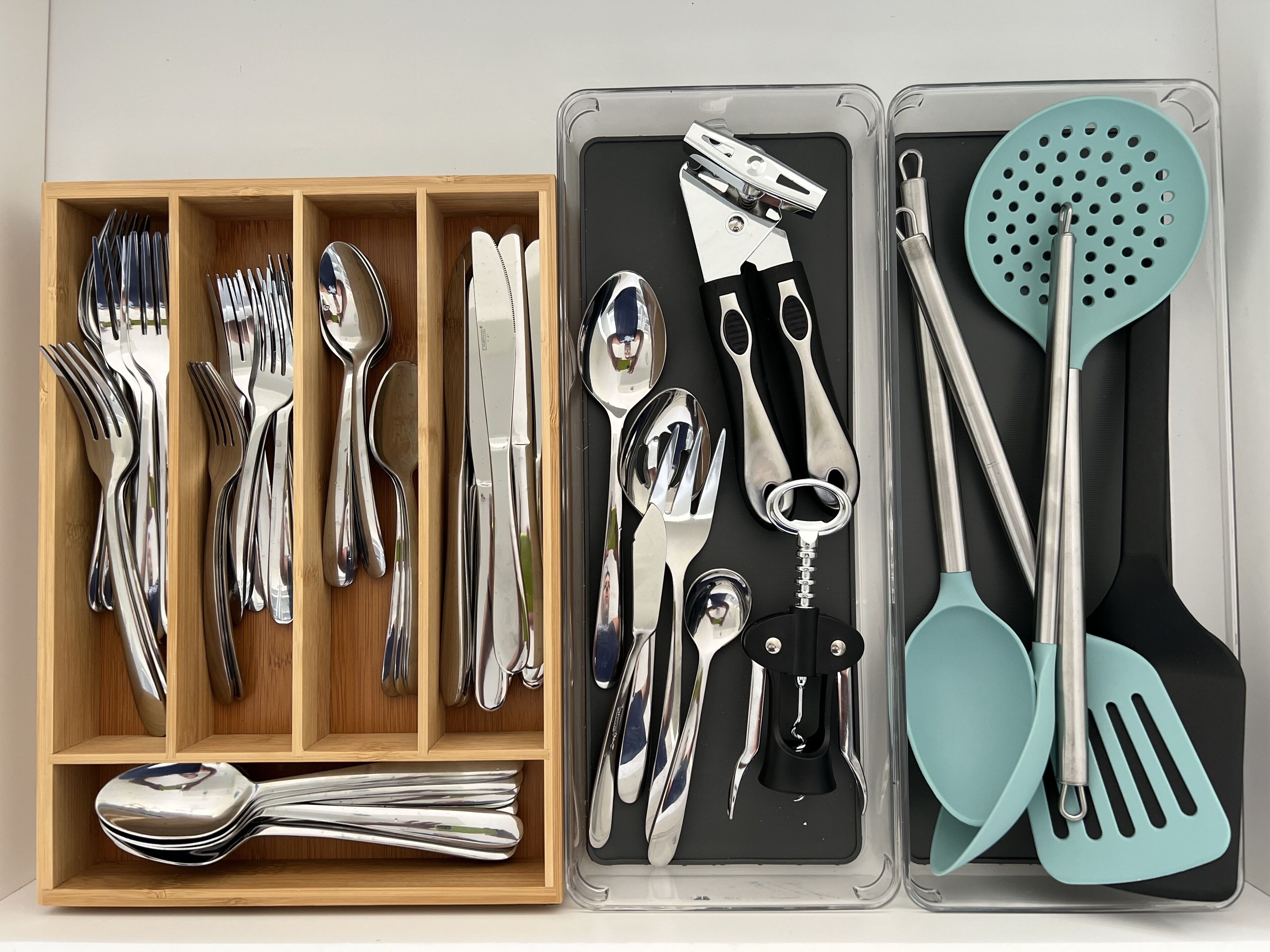 A set of kitchen utensils organized in compartments.