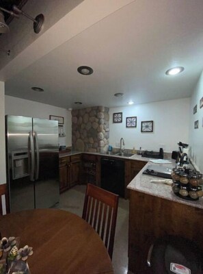 Fridge, stovetop, dishwasher, coffee/tea maker