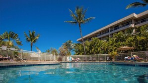 A clear blue pool surrounded by palm trees and lounge chairs, with a building in the background. - Remodeled 1BD/2BA in Best South Kihei Location, split A/C, 3 min from the beach! (Kihei)