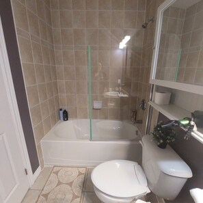 Combined shower/bathtub, hair dryer, towels, soap -  Hotel Style Bedroom and Bathroom (Guelph)