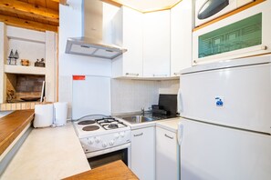 A modern kitchen with white cabinetry, a stove, a sink, and a refrigerator. - Studio Apartment Pupa - Studio Apartment (Ground Floor) (Dubrovnik)