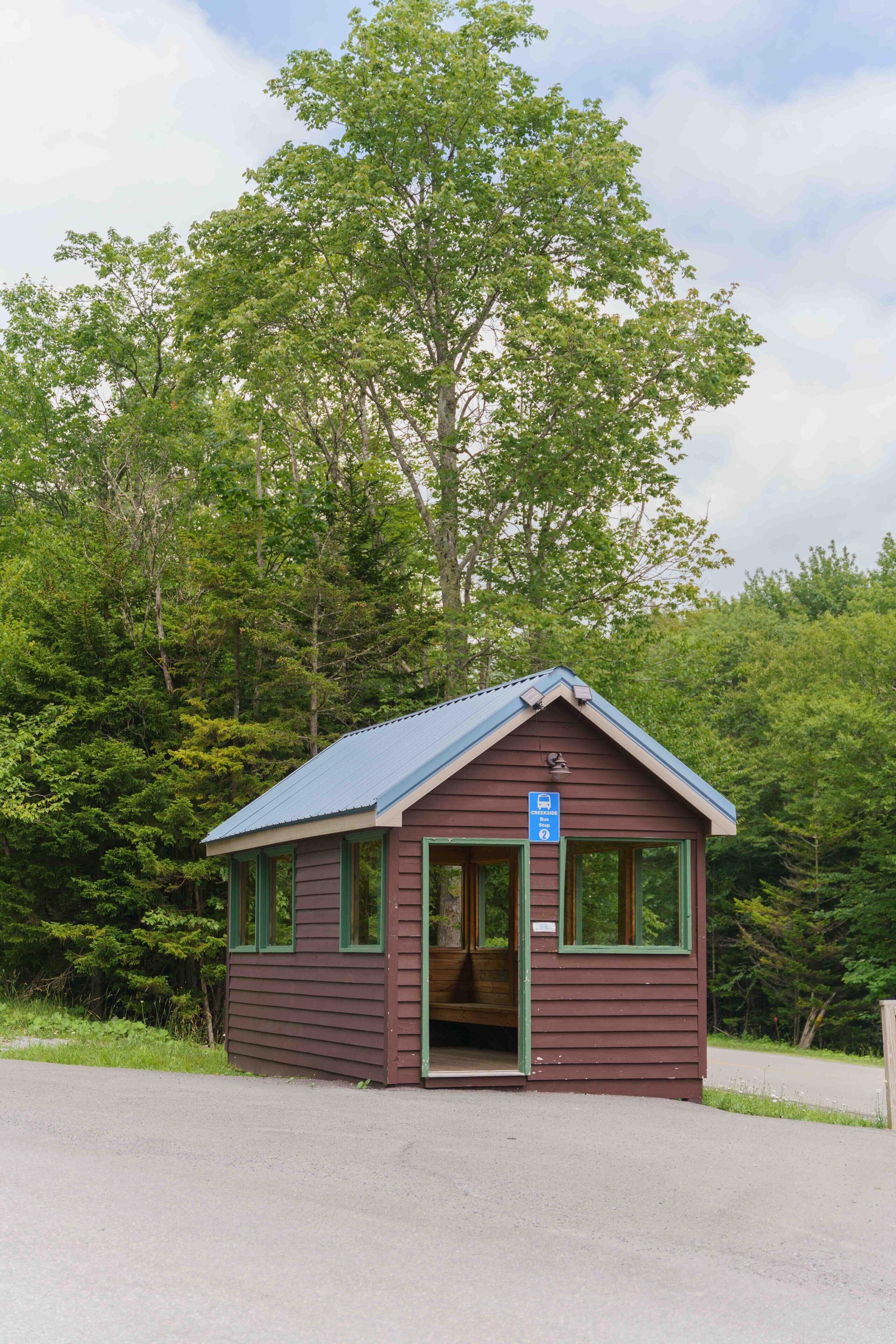 A small bus stop with a sign indicating it is a 'Crescent Bus Stop.'