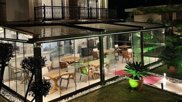 A modern building with a sign reading "DALYAN RISUS SUITE". - Dalyan Risus Suite (Cesme)