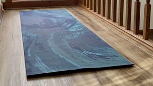 A room with a wooden floor, a blue exercise mat, a wooden railing, and a large window with a view of trees and mountains. - Jim Thorpe, Bear Creek Lake, Cozy 3Br family friendly home- EV charging outlet (Jim Thorpe)
