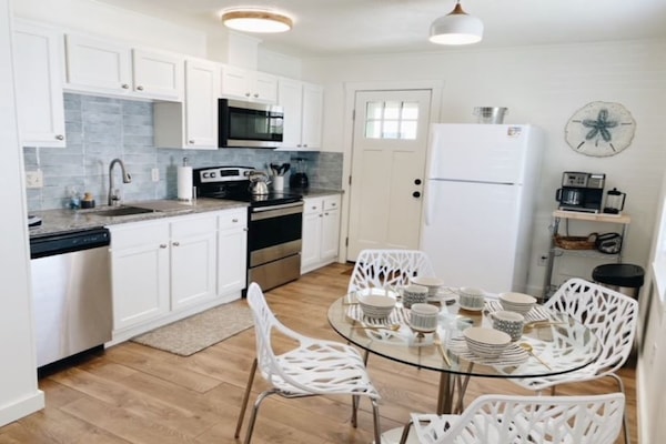 Kitchen with dining for 4 and access to back deck and outdoor shower