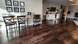 A modern kitchen with a built-in oven, microwave, and refrigerator. There are framed pictures on the wall and a welcome sign. - Long Lake Oasis: To recharge or Work with a view (Lacey)