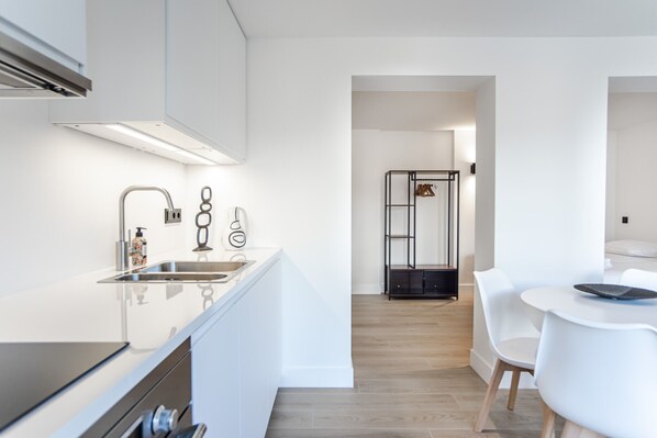 Enjoy meals in the well-lit kitchen with a dining area and sleek cabinetry.