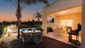 An outdoor patio with wicker furniture, a pool, and a dining area with a table and chairs. - 3 Bedroom Villa with Private Pool and Free Car (Paphos)