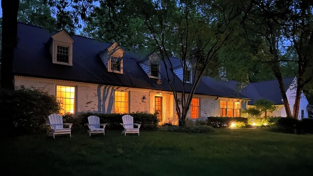 A house with a well-lit front porch, two Adirondack chairs, and a brick exterior. - Fox Knoll 1-Studio-Sleeps 2-Beautiful Setting! Indy 500! Grand Park, Concerts! (Indianapolis)