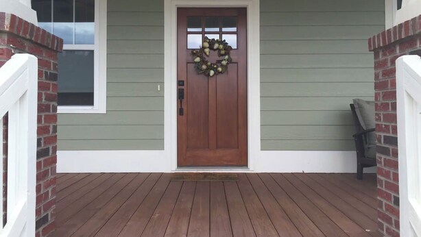 A wooden door with a wreath, a small window, and a porch with a bench. - The Nest - The Perfect Asheville Getaway; Pet Friendly!, 10 Mins to Downtown (Asheville)