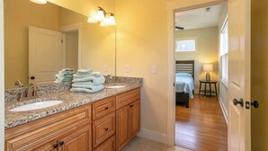 A bathroom with two sinks, a large mirror, and a towel rack. - The Nest - The Perfect Asheville Getaway; Pet Friendly!, 10 Mins to Downtown (Asheville)