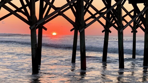 A pier structure with wooden beams and a sunset in the background. - Newly renovated 3BR/3BA w king bed, linens, towels & views! 🌞 (Surf City)