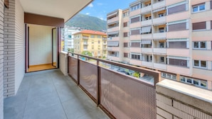 A balcony with a view of neighboring buildings and a mountain. - Locarno Best Place near Piazza Grande and Lake, Locarno, Switzerland (Locarno)